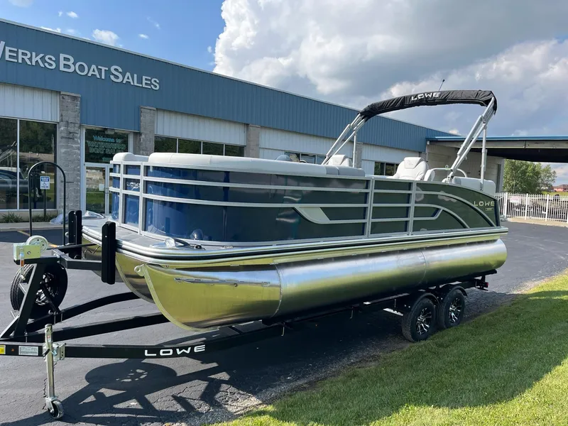 Slide: The Image of 2024 Lowe SS 210 WT pontoon boat on trailer outside dealership. - 33