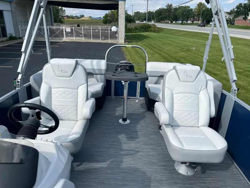 Slide: The Image of 2024 Lowe SS 210 WT pontoon boat interior with white seating and steering wheel. - 7