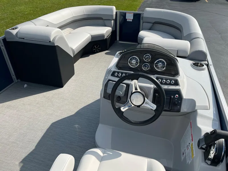 Slide: The Image of 2024 Lowe SS 210 WT pontoon boat interior with modern helm and spacious seating. - 9