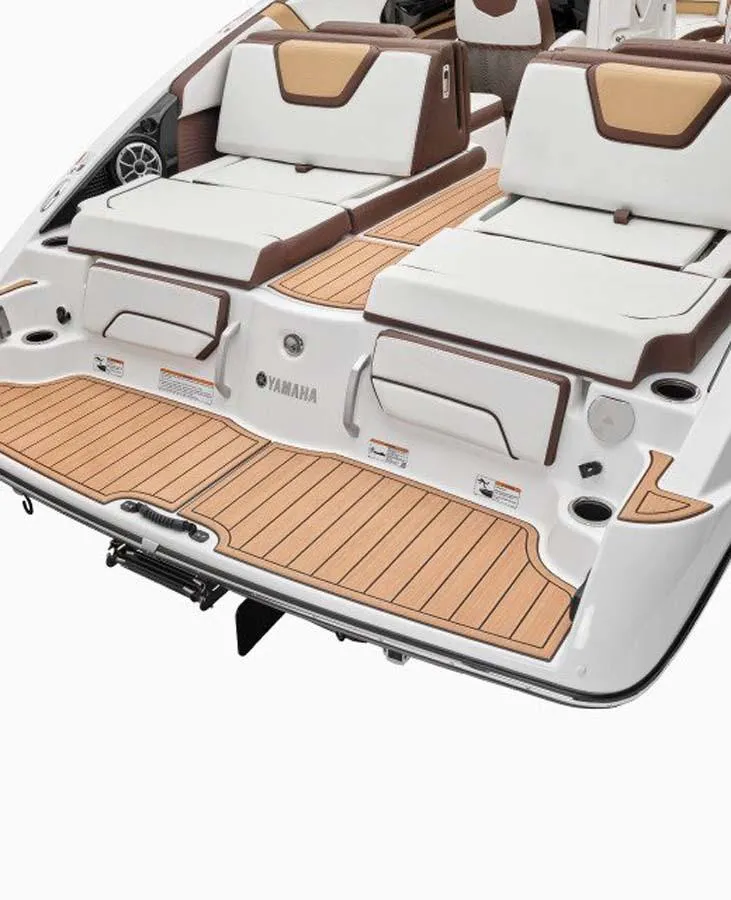 Slide: The Image of 2023 Yamaha Boats 252SD rear deck with cushioned seating and teak flooring. - 12