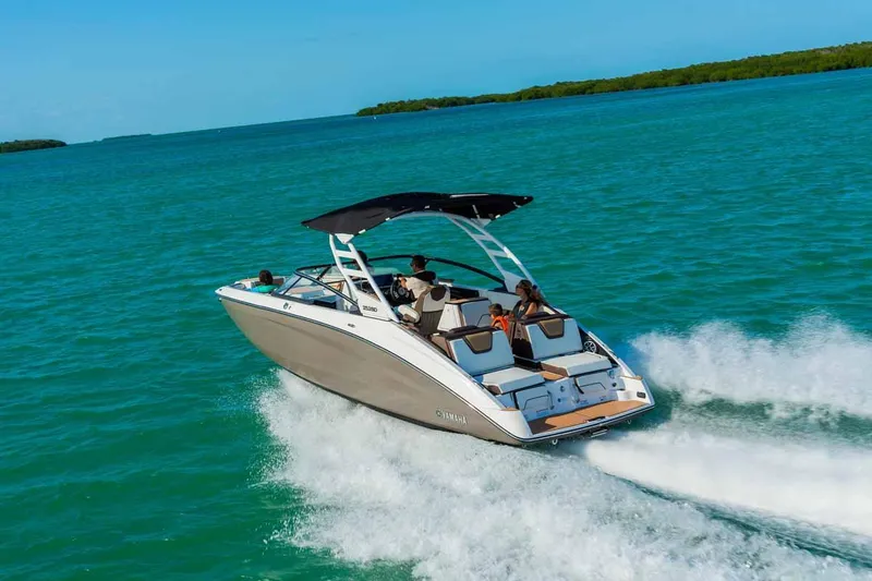 Slide: The Image of 2023 Yamaha Boats 252SD cruising on clear blue water. - 4