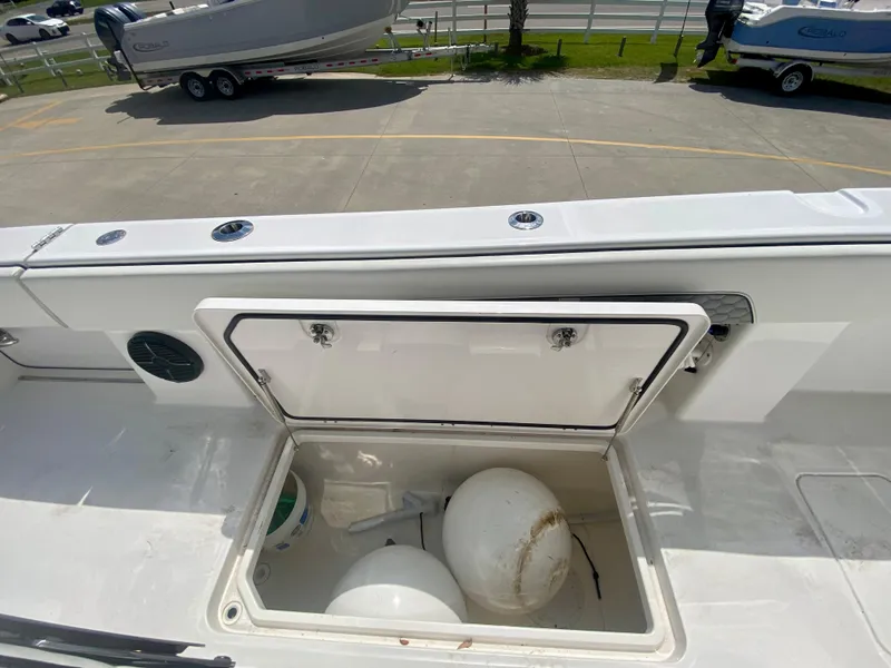 Slide: The Image of Open storage compartment on a 2022 Invincible 35 Catamaran boat. - 17
