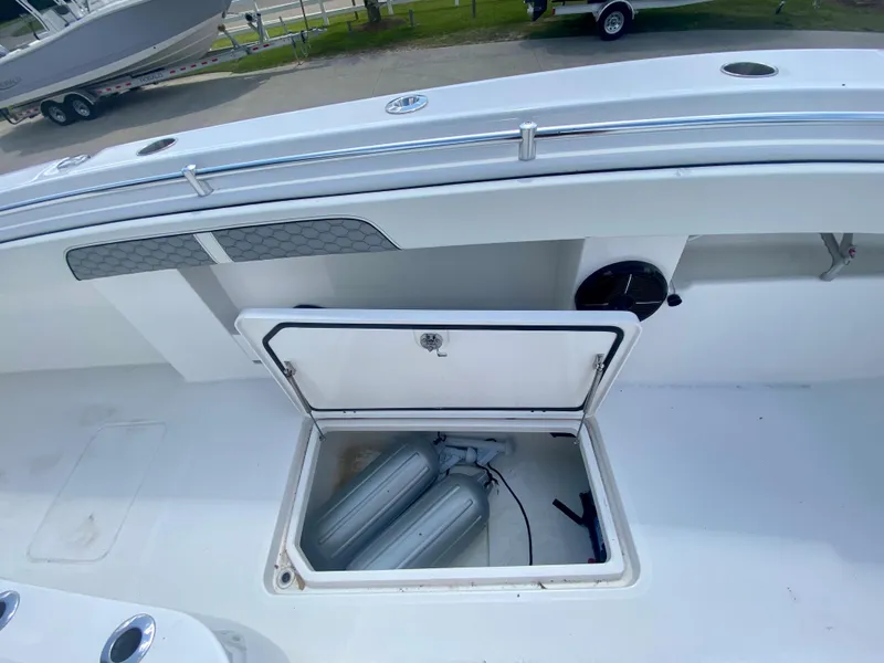 Slide: The Image of 2022 Invincible 35 Catamaran storage compartment with open hatch and visible equipment. - 30