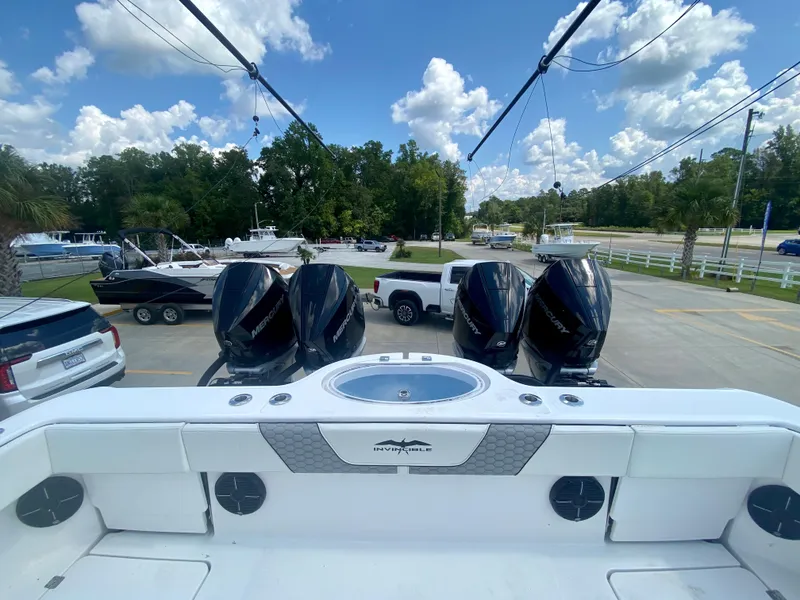 Slide: The Image of 2022 Invincible 35 Catamaran with quad outboard engines in a marina. - 5