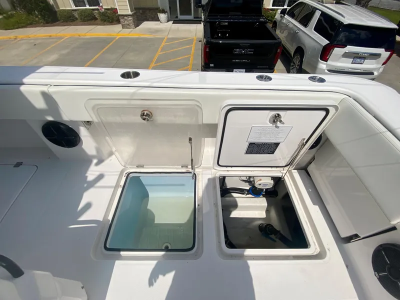 Slide: The Image of 2022 Invincible 35 Catamaran with open storage compartments and livewell. - 8