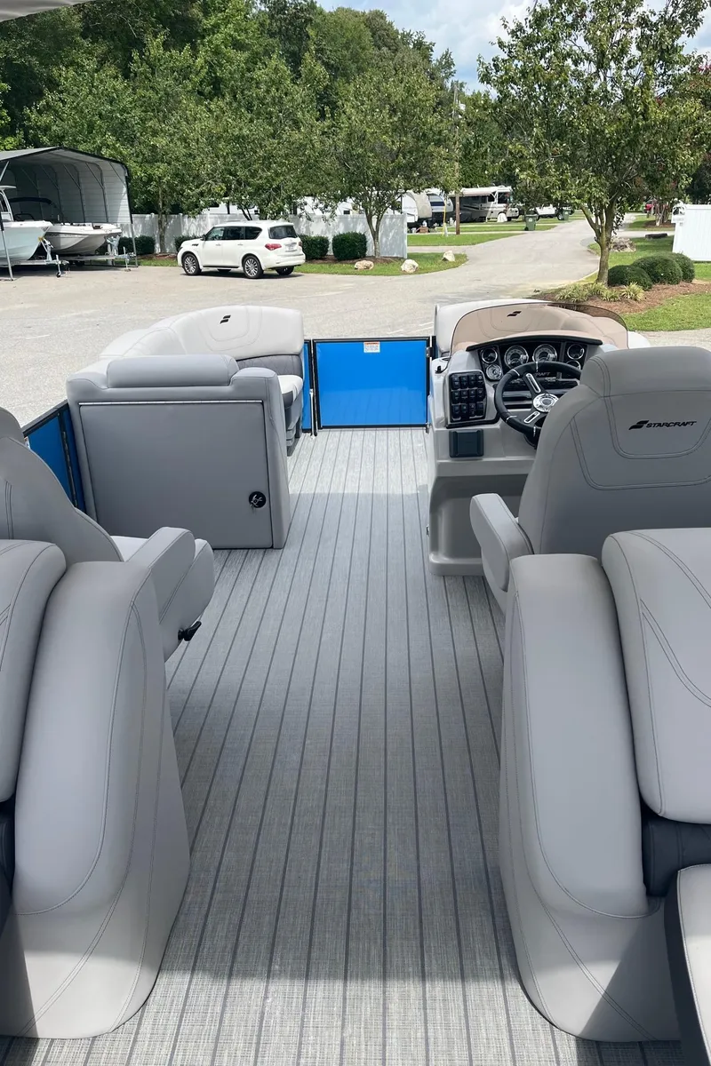 Slide: The Image of 2024 Starcraft SLS 3 boat interior with plush seating and modern dashboard. - 16