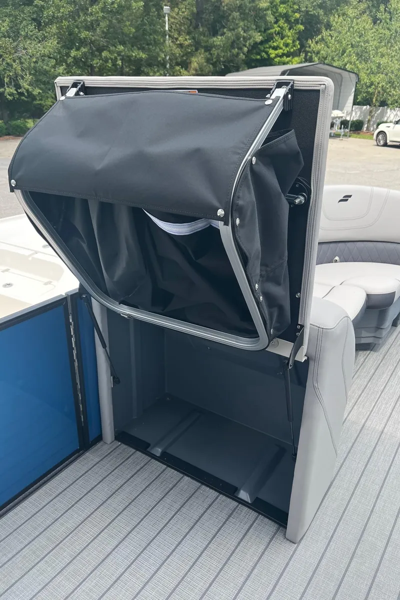 Slide: The Image of 2024 Starcraft SLS 3 boat with open storage compartment and seating area. - 18