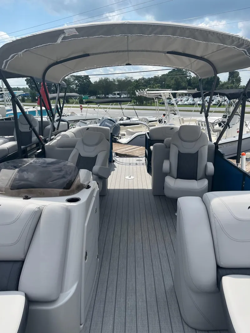 Slide: The Image of 2024 Starcraft SLS 3 pontoon boat interior with seating and canopy. - 6