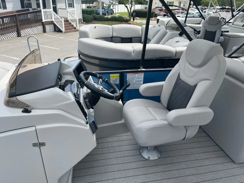 Slide: The Image of 2024 Starcraft SLS 3 boat interior with captain's chair and steering console. - 8