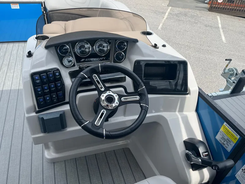 Slide: The Image of 2024 Starcraft SLS 3 boat dashboard with steering wheel and control panel. - 9