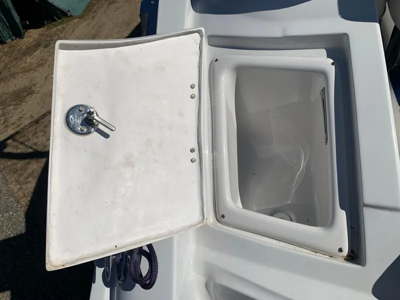 Slide: The Image of Open storage compartment on a 2012 Crownline E6 boat. - 10