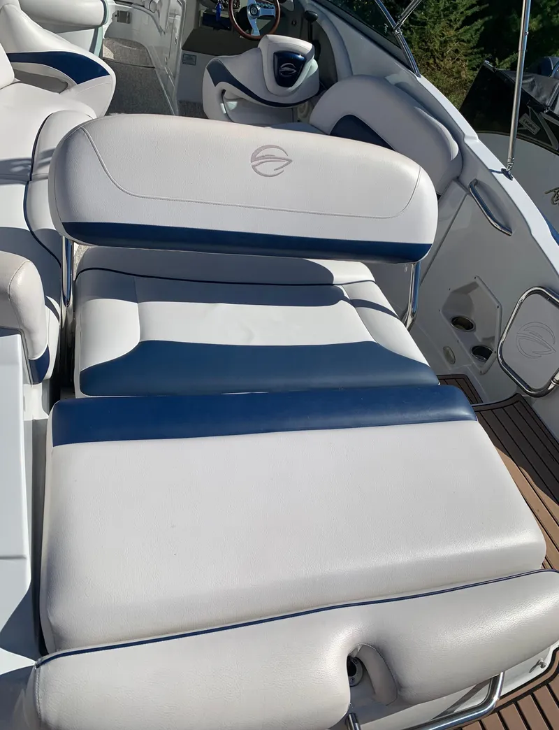 Slide: The Image of 2012 Crownline E6 boat with white and blue cushioned seating. - 12