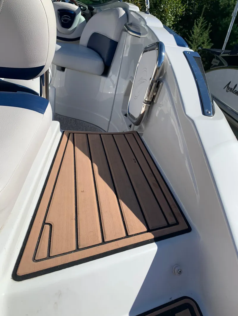 Slide: The Image of 2012 Crownline E6 boat interior with teak flooring and white seating. - 13