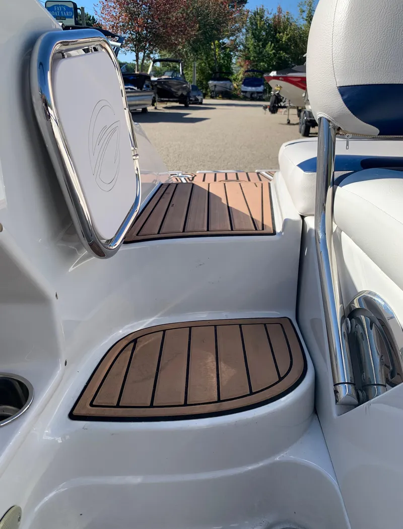 Slide: The Image of 2012 Crownline E6 boat interior with teak flooring and white seating. - 15