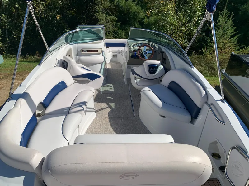 Slide: The Image of 2012 Crownline E6 boat interior with white and blue seating. - 16