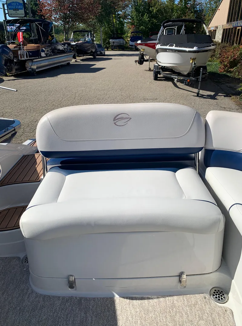 Slide: The Image of 2012 Crownline E6 boat interior seating area in a marina. - 18