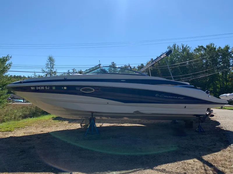 Slide: The Image of 2012 Crownline E6 boat on stands in a sunny outdoor setting. - 2