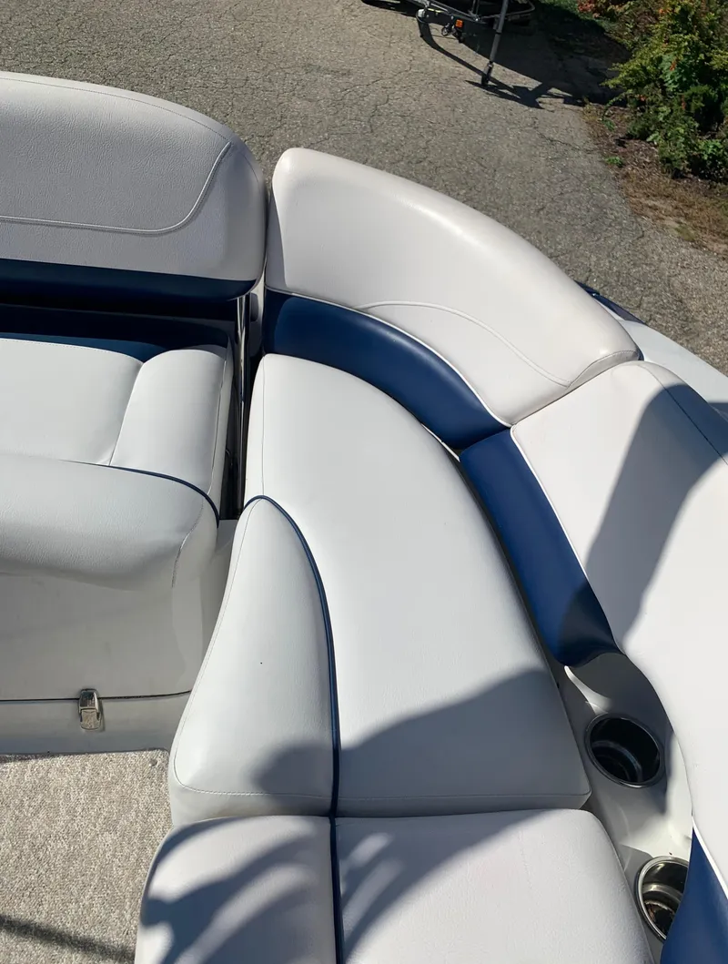 Slide: The Image of 2012 Crownline E6 boat with white and blue cushioned seating. - 21