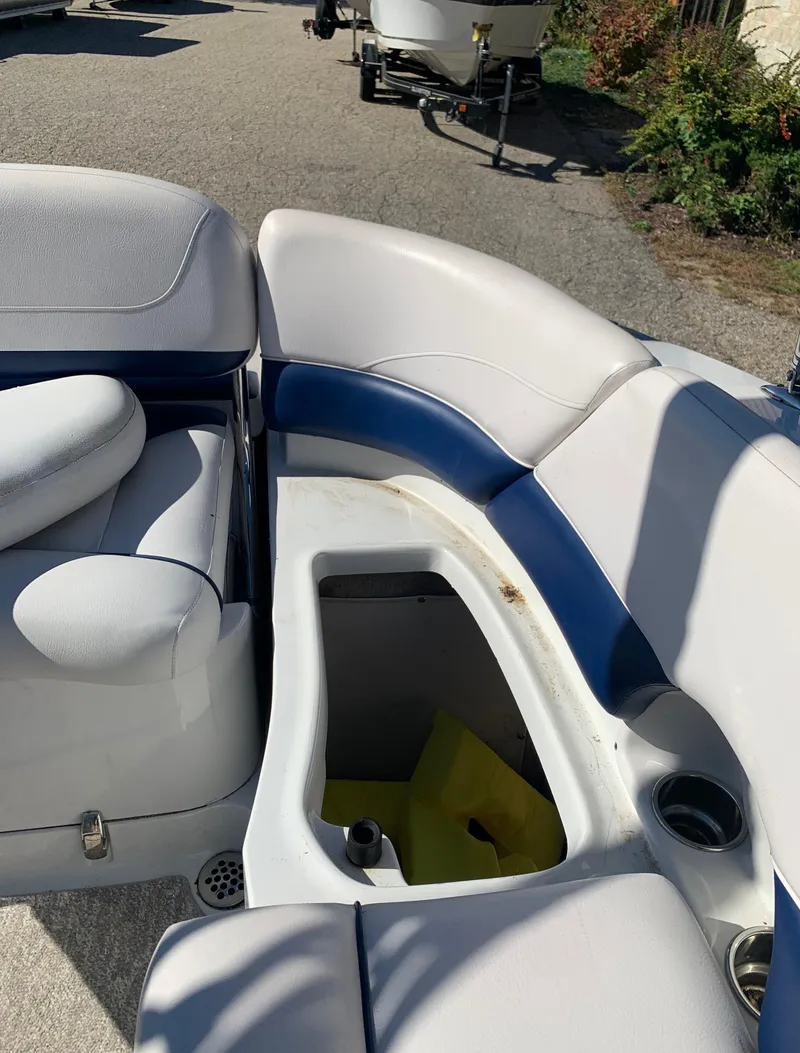 Slide: The Image of 2012 Crownline E6 boat with open storage compartment and white-blue seating. - 22