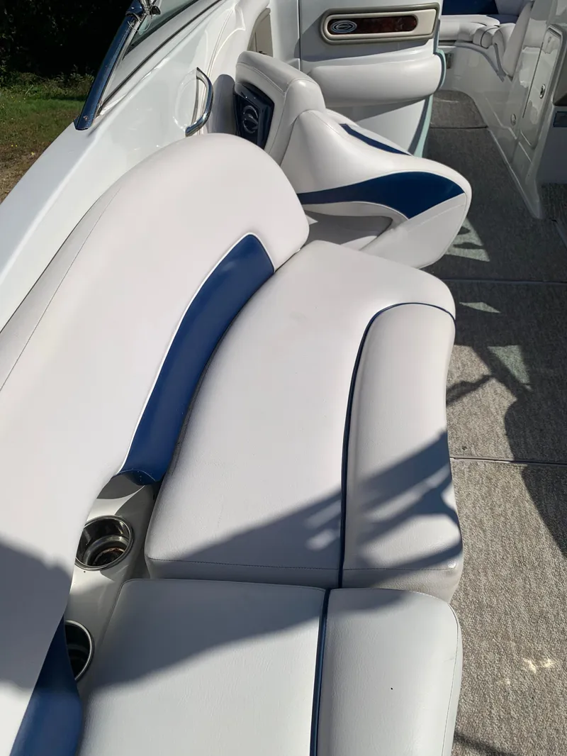 Slide: The Image of 2012 Crownline E6 boat interior with white and blue cushioned seating. - 23