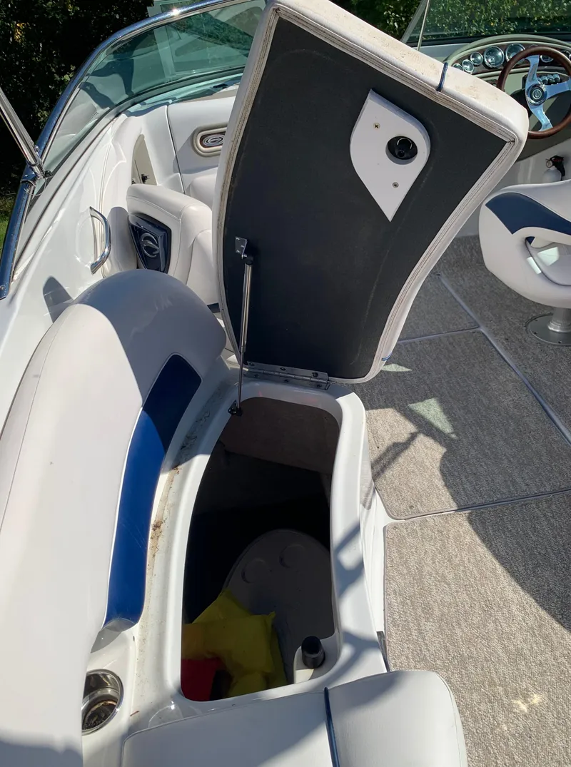 Slide: The Image of 2012 Crownline E6 boat interior storage compartment with open lid. - 24