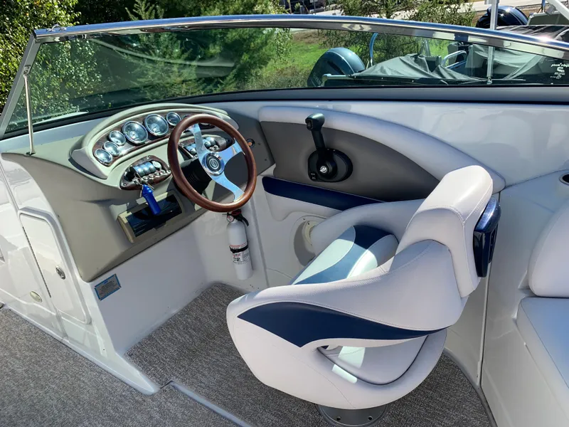 Slide: The Image of 2012 Crownline E6 boat cockpit with steering wheel and captain's chair. - 28