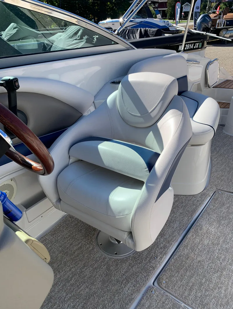 Slide: The Image of Captain's chair in a 2012 Crownline E6 boat, featuring luxurious white leather upholstery. - 31