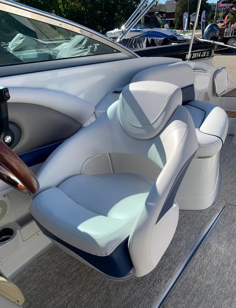 Slide: The Image of 2012 Crownline E6 boat interior with plush seating and steering wheel. - 32