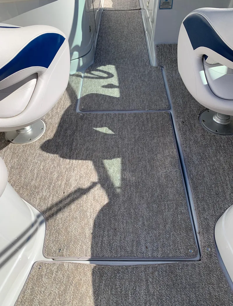 Slide: The Image of Interior of a 2012 Crownline E6 boat with carpeted flooring and cushioned seats. - 33