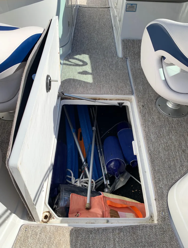 Slide: The Image of Storage compartment on a 2012 Crownline E6 boat with various boating equipment. - 34