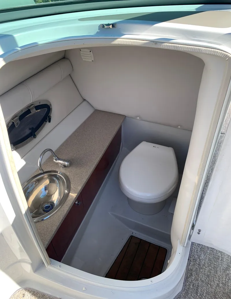 Slide: The Image of 2012 Crownline E6 boat interior bathroom with sink and toilet. - 39