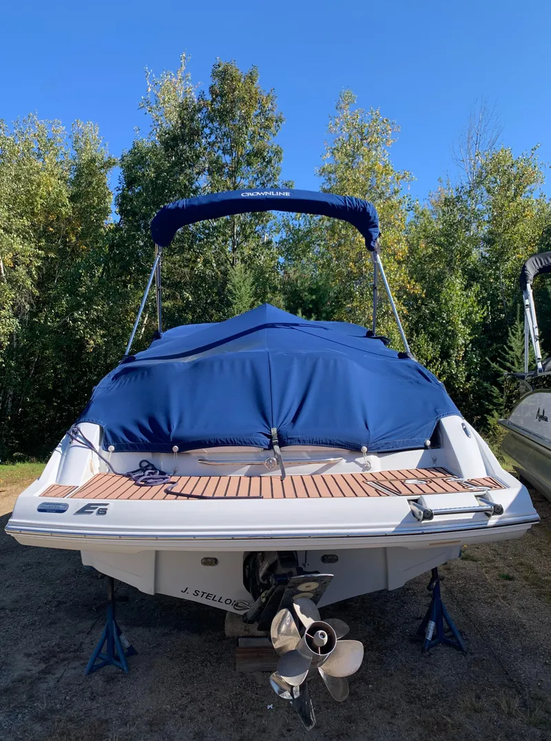 Slide: The Image of 2012 Crownline E6 boat with blue cover, rear view. - 4