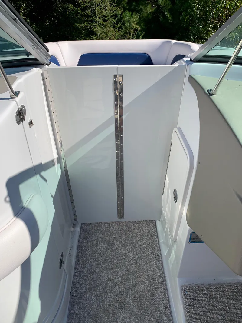 Slide: The Image of 2012 Crownline E6 boat interior with carpeted floor and seating area. - 41