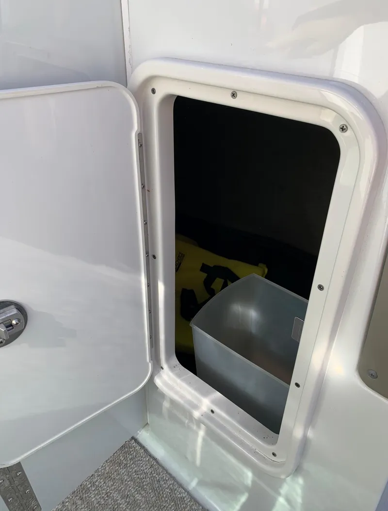 Slide: The Image of Open storage compartment on a 2012 Crownline E6 boat. - 43
