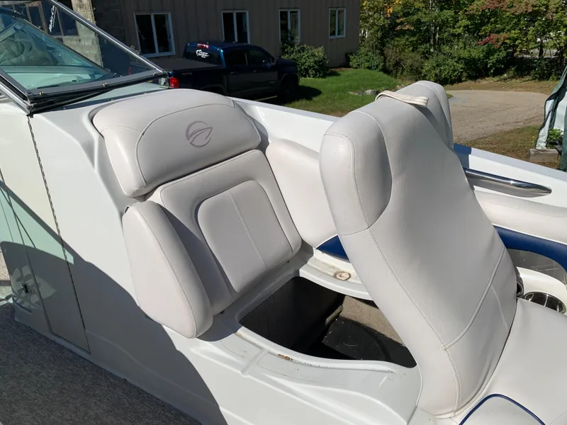 Slide: The Image of 2012 Crownline E6 boat with white leather seats in a sunny outdoor setting. - 46