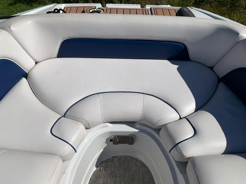 Slide: The Image of 2012 Crownline E6 boat with white and blue cushioned seating. - 48
