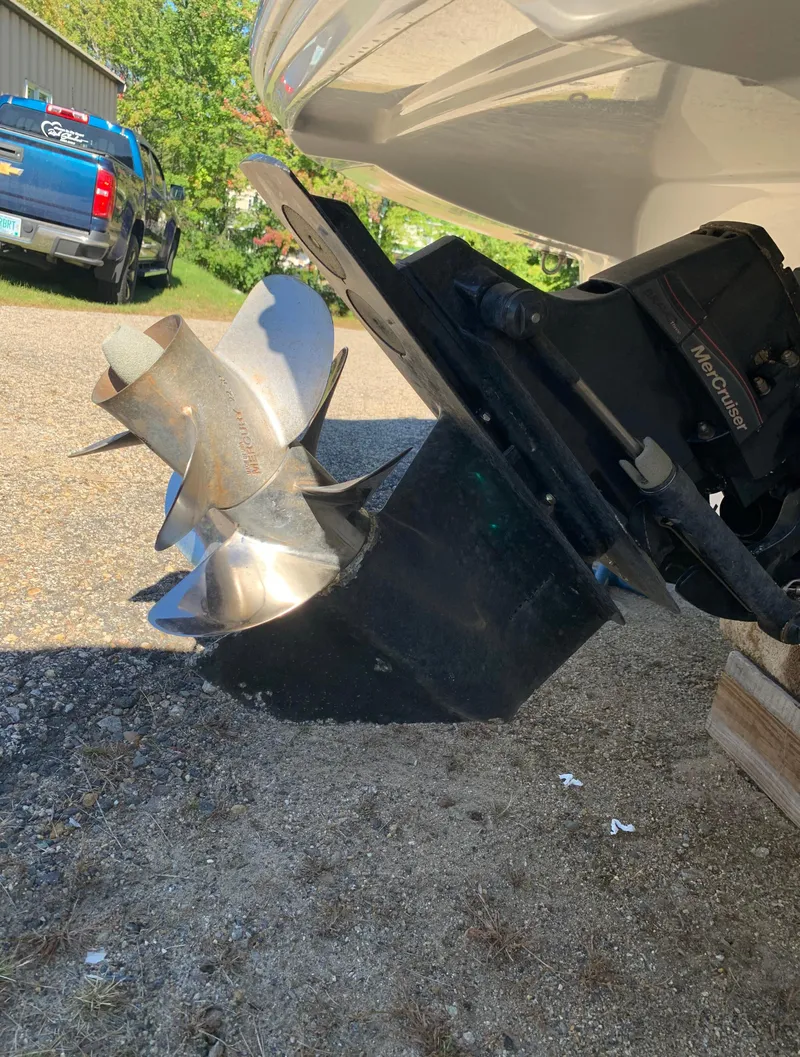 Slide: The Image of 2012 Crownline E6 boat propeller and outdrive on gravel surface. - 5