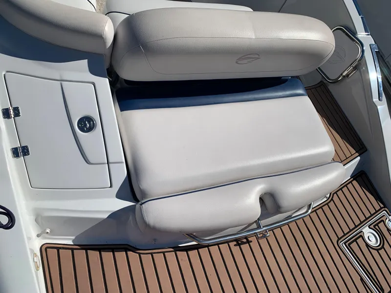 Slide: The Image of 2012 Crownline E6 boat interior with white cushioned seating and teak flooring. - 8