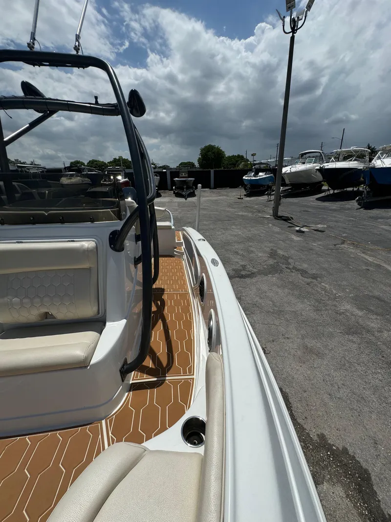 Slide: The Image of 2016 Pronautica 660 boat docked with a view of the deck and surrounding boats. - 11