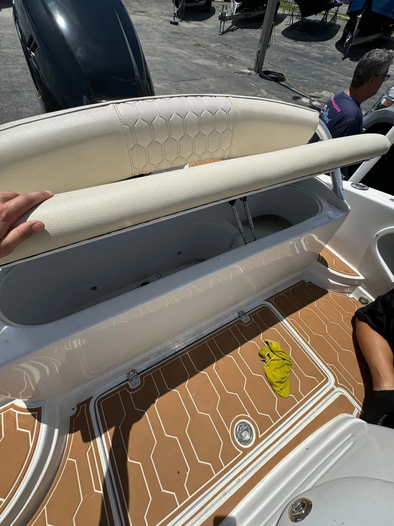 Slide: The Image of 2016 Pronautica 660 boat with open storage compartment and tan deck. - 14