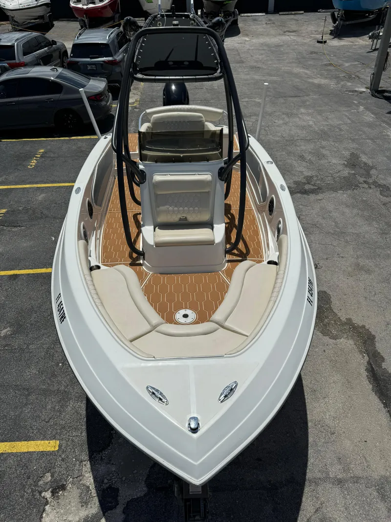 Slide: The Image of 2016 Pronautica 660 boat with white exterior and tan interior, docked in a marina. - 19