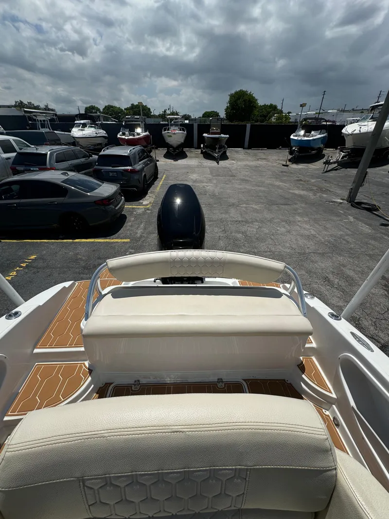 Slide: The Image of 2016 Pronautica 660 boat in a parking lot with other vehicles and boats. - 26