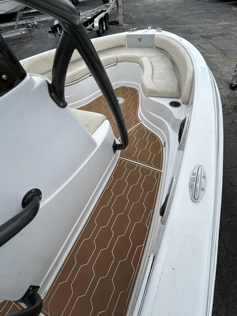 Slide: The Image of 2016 Pronautica 660 boat with white seating and brown deck. - 3