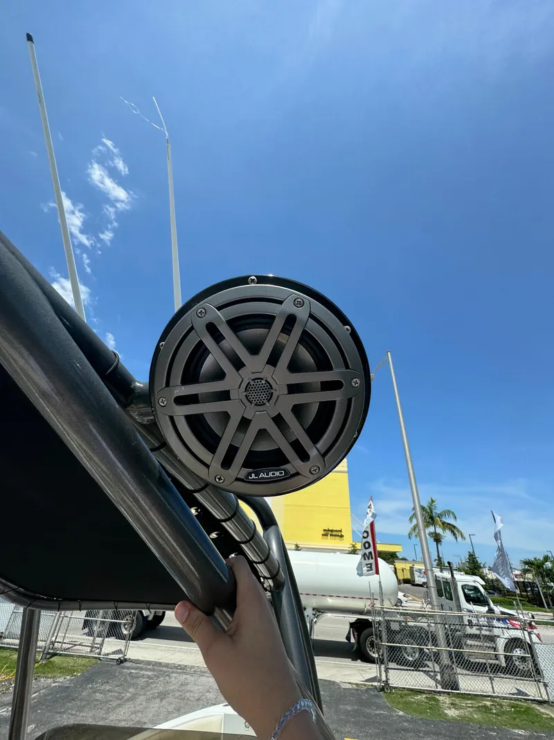Slide: The Image of Close-up of a speaker on a 2016 Pronautica 660 boat under a clear blue sky. - 31