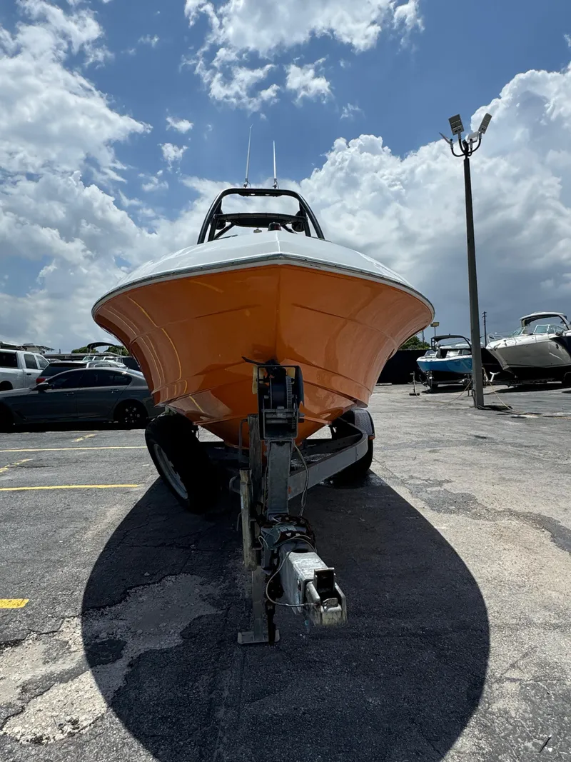 Slide: The Image of 2016 Pronautica 660 boat on trailer under cloudy sky. - 34