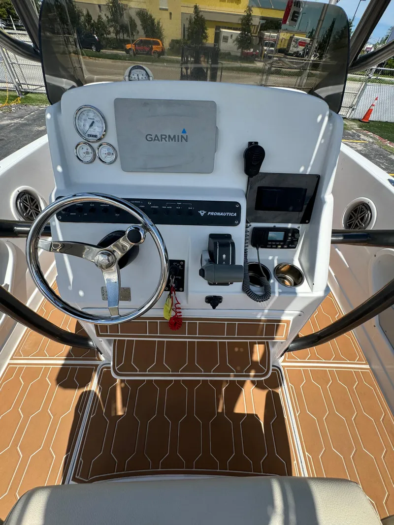 Slide: The Image of 2016 Pronautica 660 boat dashboard with Garmin navigation system and steering wheel. - 44