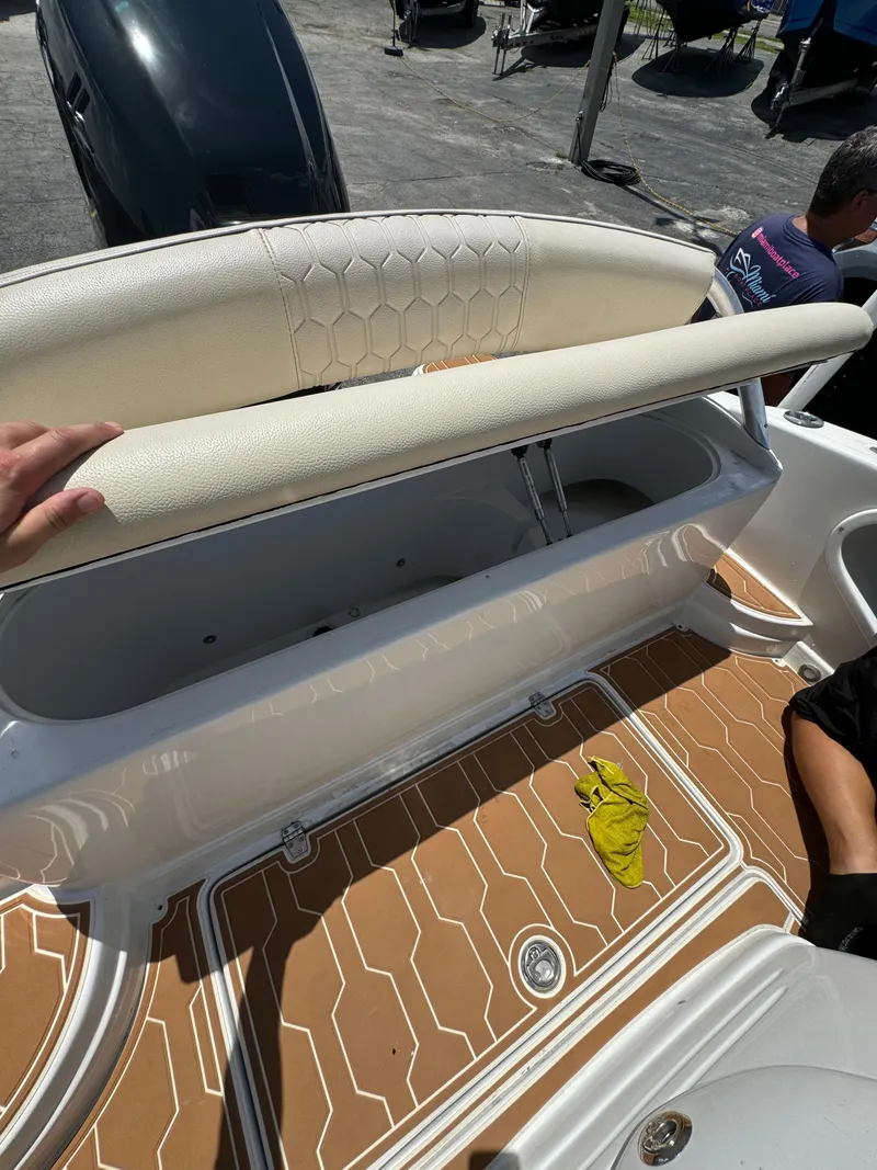 Slide: The Image of 2016 Pronautica 660 boat with open storage compartment and cushioned seating. - 45