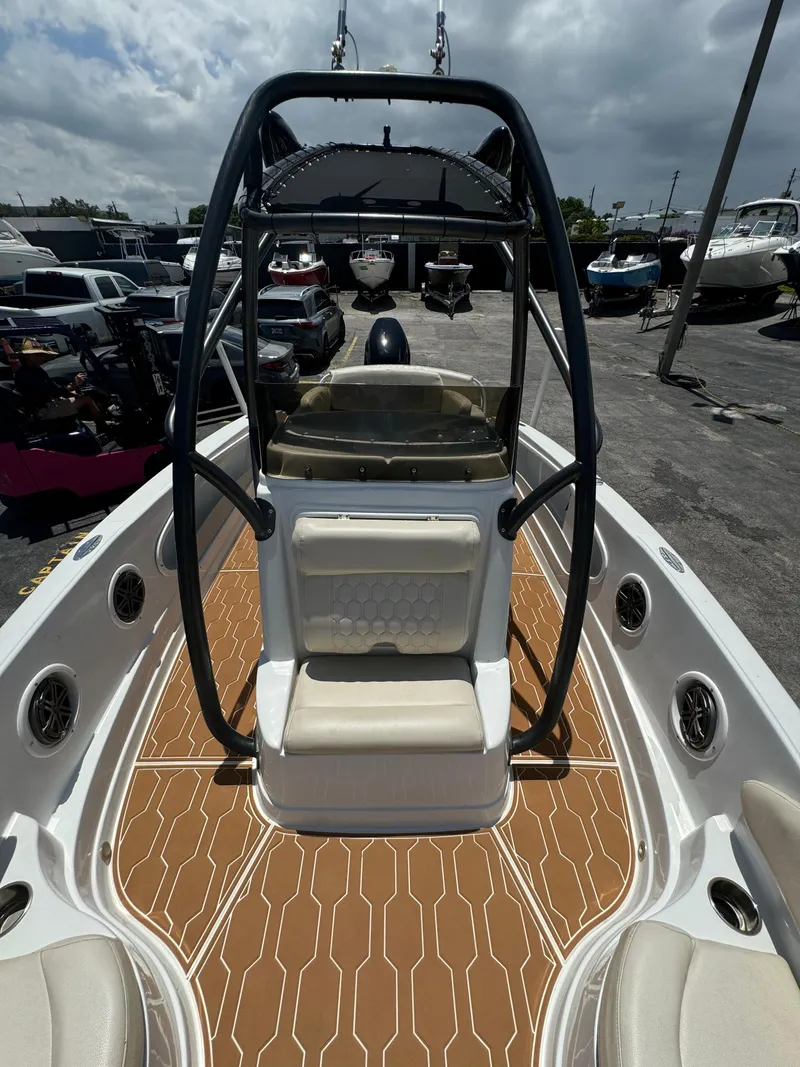 Slide: The Image of 2016 Pronautica 660 boat with tan deck and black frame, docked in a marina. - 46