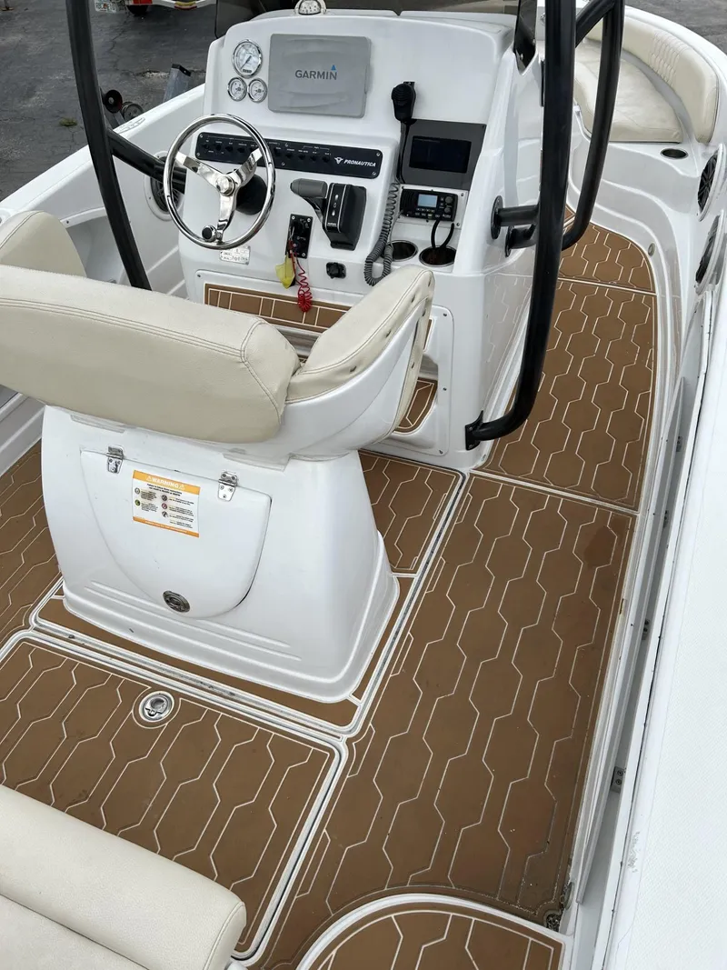Slide: The Image of 2016 Pronautica 660 boat interior with beige seating and brown flooring. - 5