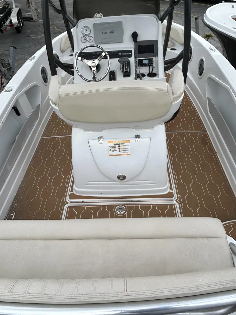 Slide: The Image of 2016 Pronautica 660 boat interior with beige seating and brown deck. - 6